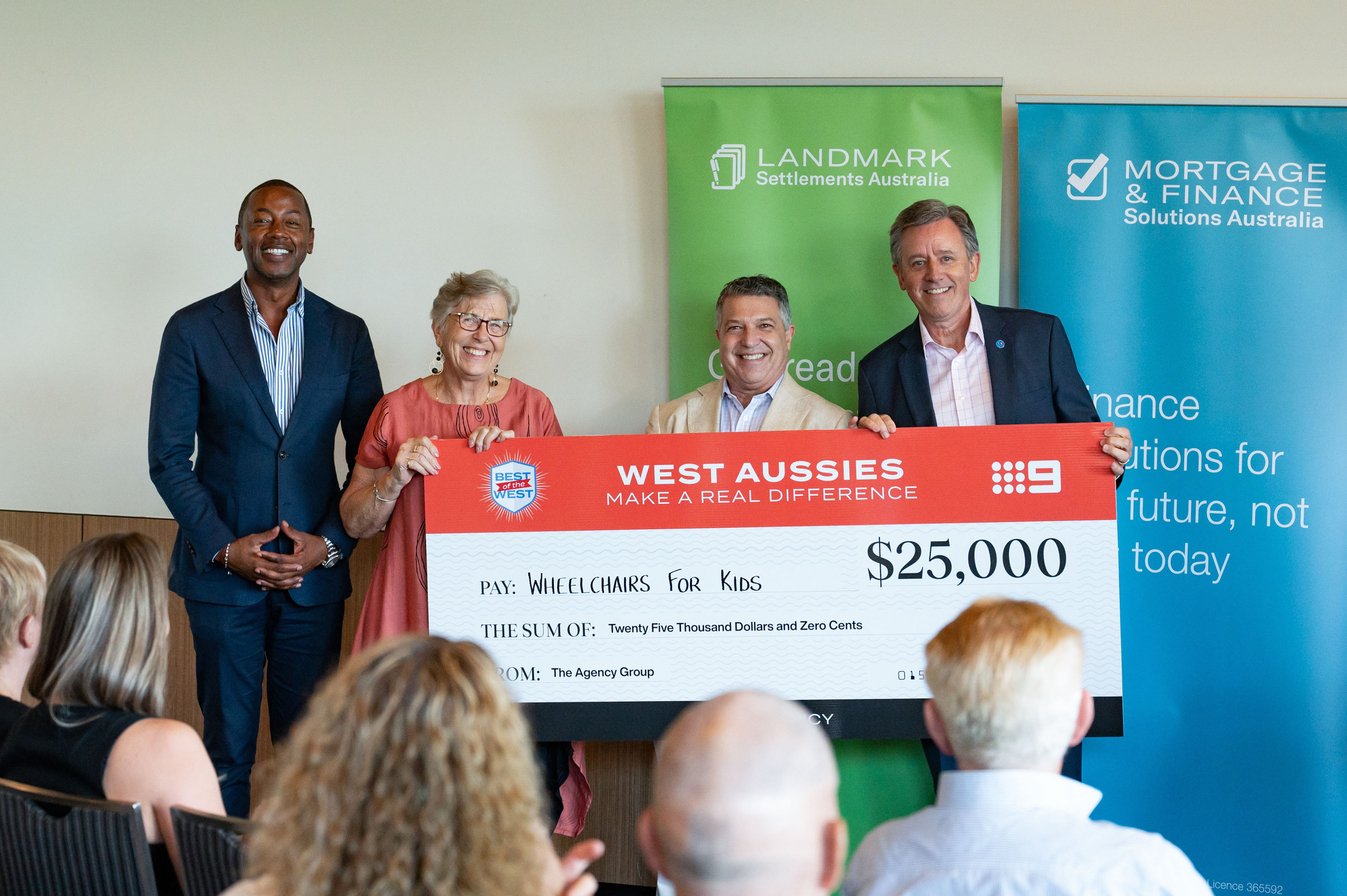 Wheelchairs For Kids Australia CEO Greg Hebble (right) and Wheelchairs For Kids Australia volunteer Jenny Prince (second from left) accepting the Best of the West $25,000 cheque from The Agency Group National Founder and Executive Director Paul Niardone.